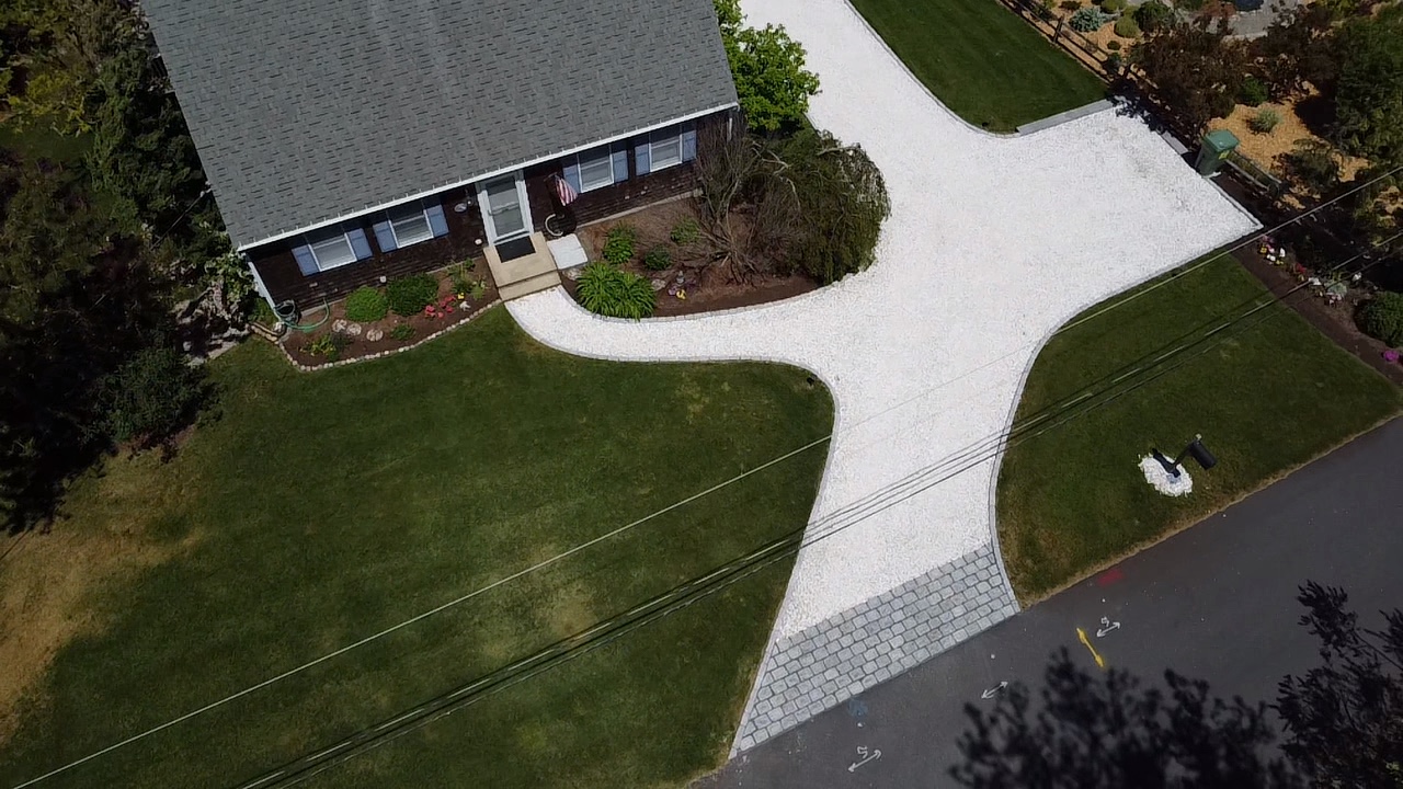 Aerial view of gravel driveway and lawn