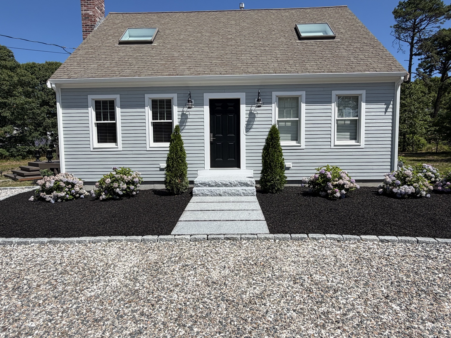 Front entry stone steps and landscaped beds